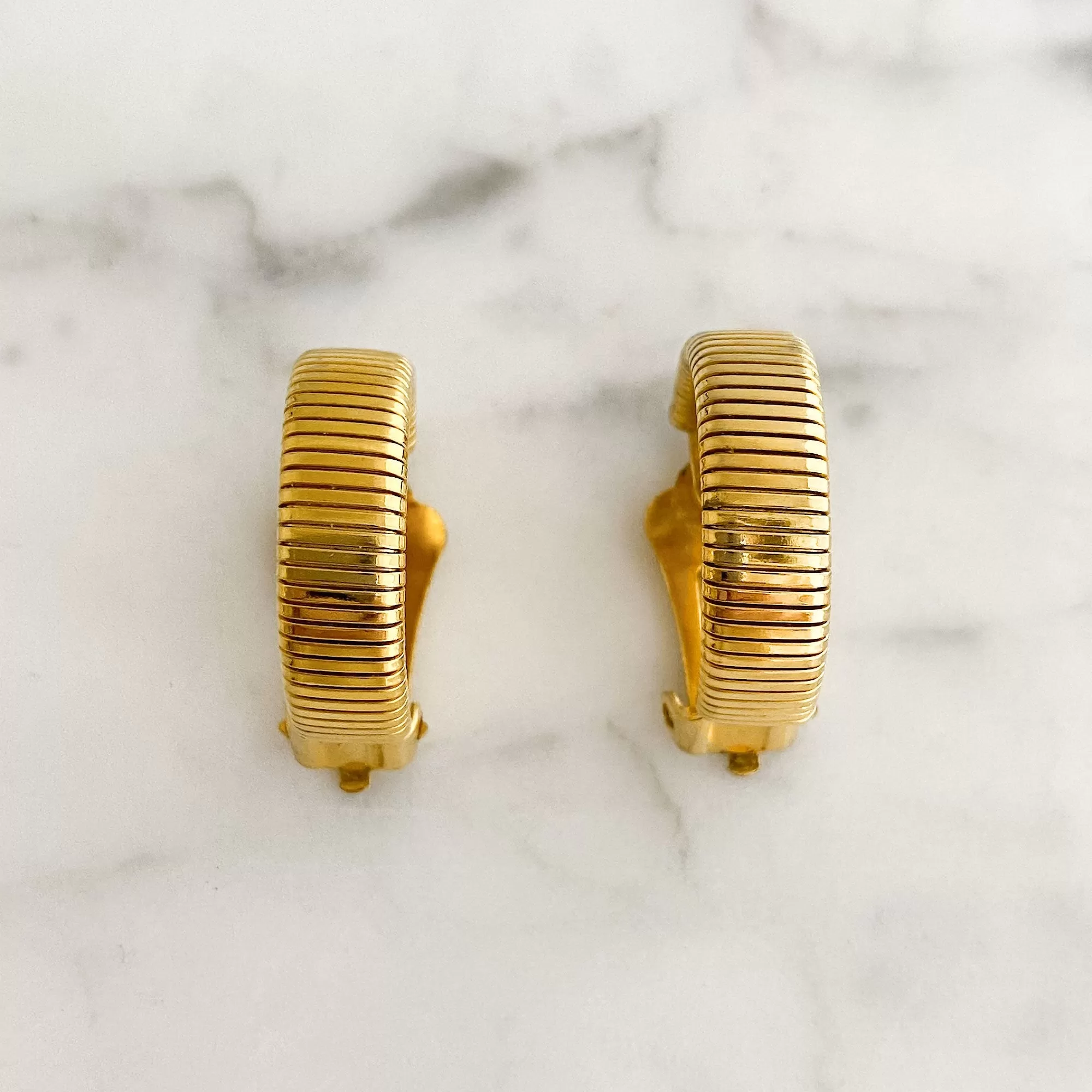 KRYSTAL gold tone omega hoop clip earrings