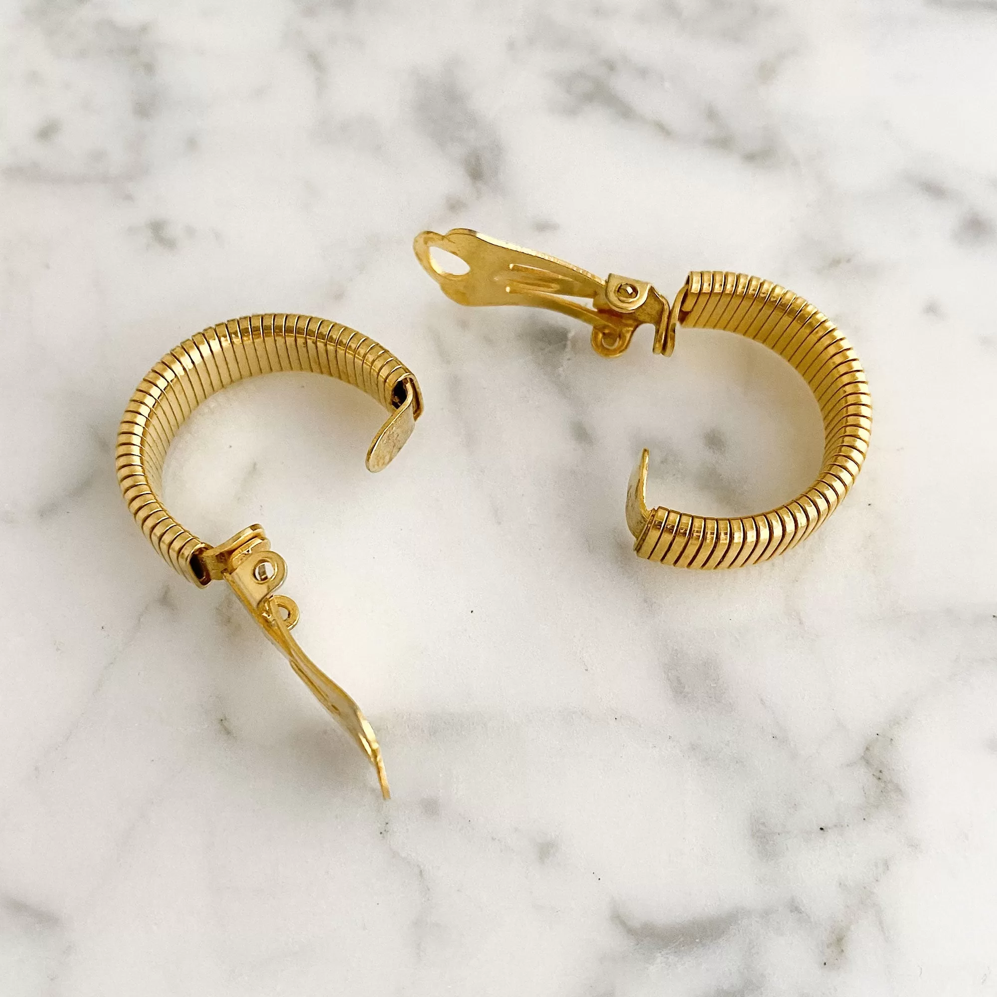 KRYSTAL gold tone omega hoop clip earrings